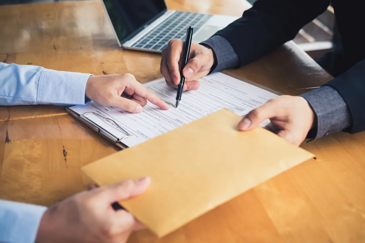Professionals reviewing and signing an agreement